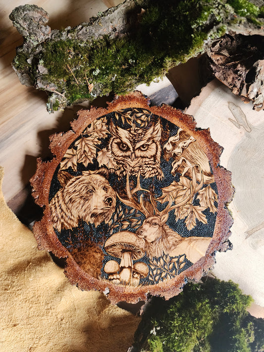 wildlife depicted in pyrographic art, an owl, bear and elk with burn art mushrooms and leaves