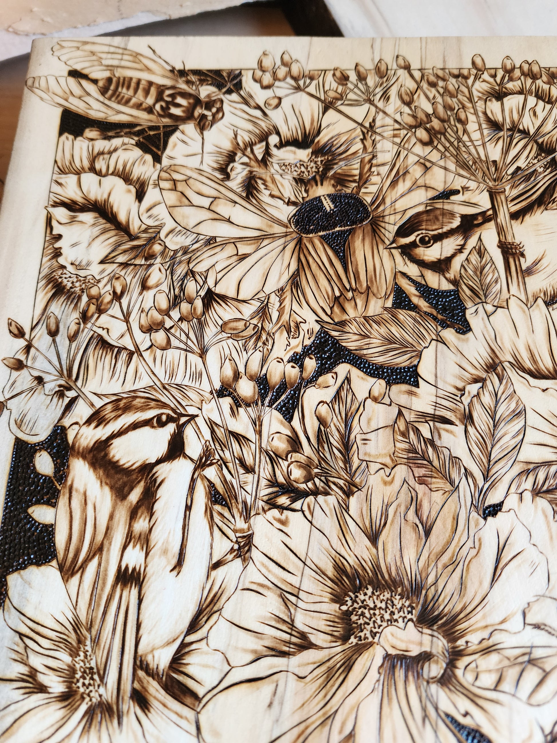 wood burned art of bees and flowers