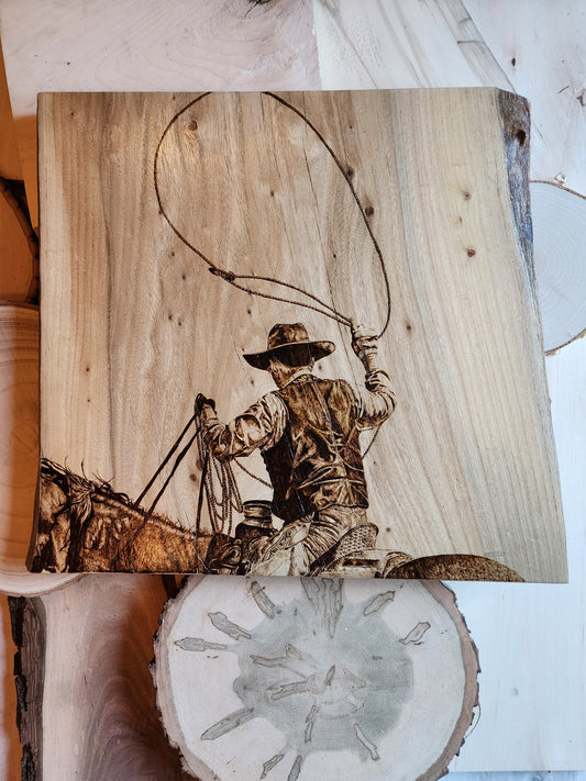 pyrographic artwork of a roping cowboy
